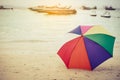 Rainbow color umbrella on beach. Holiday and Forgotten Object co