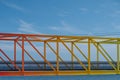 Rainbow colored bridge with ocean background - colorful steel br Royalty Free Stock Photo