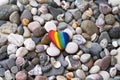 Rainbow colored stone on the beach