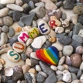 Rainbow colored stone and word Summer on the beach Royalty Free Stock Photo