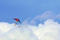 Rainbow colored kite in the clouds Royalty Free Stock Photo