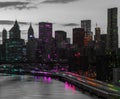 Rainbow colored lights shining on the black and white skyline buildings of New York City at night Royalty Free Stock Photo