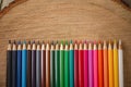 Rainbow of colored pencils on wood background Royalty Free Stock Photo
