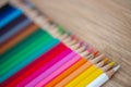 Rainbow of colored pencils on wood background Royalty Free Stock Photo