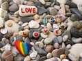 Rainbow colored stone and message on the beach