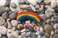 Rainbow colored stone and word Love on the beach Royalty Free Stock Photo