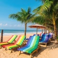 Rainbow colored sunbeds stay on summer beach under palms and blue sky. Vacation concept on seascape background on