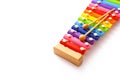 Rainbow colored toy xylophone with two sticks on white background. Copy space Royalty Free Stock Photo