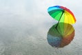 Rainbow colored umbrella at the beach Royalty Free Stock Photo