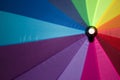 Rainbow colored umbrella in smooth focus, opened on the background Royalty Free Stock Photo