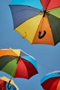 Rainbow colored umbrellas hanging in the sky. Summer travel. LGBT pride