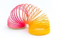 Rainbow colored wire spiral toy on white background Royalty Free Stock Photo