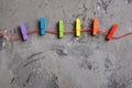 Rainbow colored wooden clothespins and red hearts on grey concrete background. Royalty Free Stock Photo