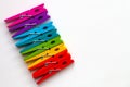 Rainbow colored wooden clothespins on white background with copy space/diversity concept Royalty Free Stock Photo