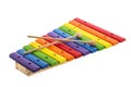 Rainbow colored wooden toy xylophone against white background Royalty Free Stock Photo