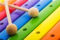 Rainbow colored wooden toy xylophone against white background Royalty Free Stock Photo