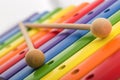 Rainbow colored wooden toy xylophone against white background Royalty Free Stock Photo