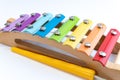 Rainbow colored wooden toy xylophone against white background. Royalty Free Stock Photo