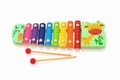 Rainbow colored wooden toy xylophone isolated on white background with shadow reflection. Royalty Free Stock Photo