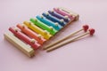 Rainbow Colored Wooden Toy Xylophone on pink bacground. toy glockenspiel made of metal and wood Royalty Free Stock Photo