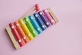 Rainbow Colored Wooden Toy Xylophone on pink bacground. toy glockenspiel made of metal and wood Royalty Free Stock Photo