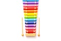 Rainbow colored wooden toy xylophone with two sticks on white background. Royalty Free Stock Photo