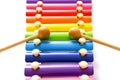 Rainbow colored wooden toy xylophone with two sticks on white background. Close up Royalty Free Stock Photo