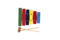 Rainbow colored wooden toy xylophone with two sticks on white background Royalty Free Stock Photo