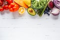 Rainbow colors vegetables and berries on white background, top view. Detox, vegan food, ingredients for juice and salad