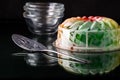 A rainbow coloured fruit flavoured jelly mold dessert, ready for serving.
