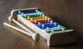 Rainbow coloured xylophone on wooden background angle view. meta Royalty Free Stock Photo