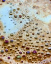Rainbow of colours in the bubbles on a coffee cup