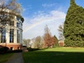 Rainbow cuts through blue sky beyond Oregon State University library atrium. Royalty Free Stock Photo