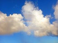 Rainbow detail between white clouds and tropical blue sky. Spectacular sky with white clouds and rainbows. Rainbow in blue sky Royalty Free Stock Photo