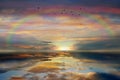 Rainbow Dramatic pink gold blue   sunset  yellow  blue cloudy   dramatic  blue stormy sky sun down reflection on sea water ,nature Royalty Free Stock Photo