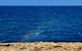 Rainbow effect on the Maltese coastline with the sunlight going through sea spray droplets Royalty Free Stock Photo