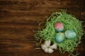 Eggs of delicate color lie on a green paper nest Royalty Free Stock Photo