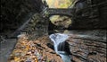 rainbow falls at watkins glen state park (waterfall in a gorge with stone bridge, staircase, glacial rock formation) Royalty Free Stock Photo