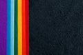 LGBT coloful beautiful sheets of felt rainbow colors on a black background copy space