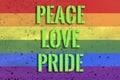Rainbow flag on background with raindrops and inscription peace love pride