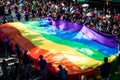 Rainbow flag carried by people collecting donations during pride parade