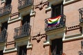 Rainbow flag of gay community on the balcony of classical building downtown Madrid, Spain