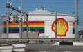 Rainbow flag and Shell logo on tank and pipes in the chemical industries in the Botlek Harbor in Rotterdam