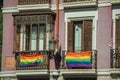Rainbow flags tied on balustrade in old building balconies at Madrid