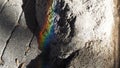 Rainbow formed on a rock on The ground