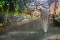 Rainbow from the fountain in a decorative small pond, a symbol of happiness. Royalty Free Stock Photo