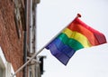 Rainbow gay pride flag on building exterior in Amsterdam Royalty Free Stock Photo