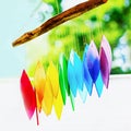 Rainbow glass wind chimes or windchime on nature background. Feng shui symbol. Copy space Royalty Free Stock Photo