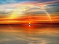 Rainbow gold orange sunset dramatic cloudy sky lilac pink sea water reflection sunlight evening summer seascape landscape Royalty Free Stock Photo