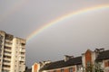 Rainbow in the gray sky over the rooftops Royalty Free Stock Photo